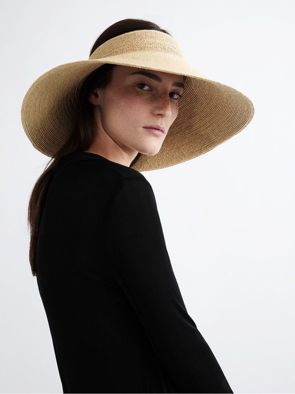 Janessa Leone Birdie adjustable visor crafted from raffia straw. Packable. O/S